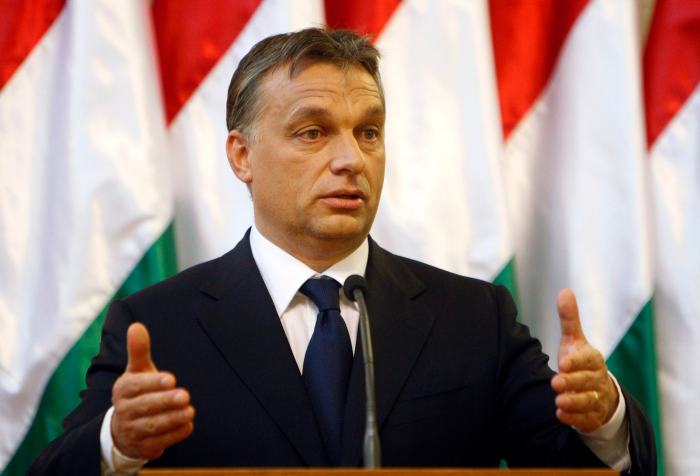 Hungary's PM Orban gestures during a joint news conference with Audi Chairman Stadler in Budapest