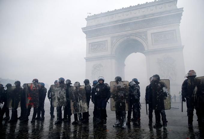 FILE PHOTO: French riot police stand guard at the Arc de Triomphe during clashes with protesters wearing yellow vests, a symbol of a French drivers' protest against higher diesel taxes, at the Place de l'Etoile in Paris