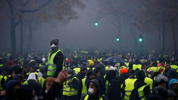 Protesters wearing yellow vests, a symbol of a French drivers' protest against higher diesel taxes, demonstrate near the Place de l'Etoile in Paris